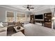 Spacious living room with large windows, a comfortable couch, and a mounted TV, ideal for relaxation at 1351 Ashbury Park Dr, Hoschton, GA 30548
