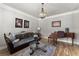 Cozy living room featuring hardwood floors, elegant furnishings, and a decorative chandelier at 1351 Ashbury Park Dr, Hoschton, GA 30548