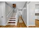 Bright hallway featuring hardwood floors, staircase, and neutral paint, creating a welcoming space at 250 Peachtree Hollow Ct, Atlanta, GA 30328