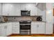 Kitchen featuring white cabinets, stainless steel appliances, and granite countertops at 250 Peachtree Hollow Ct, Atlanta, GA 30328