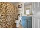 This bathroom features a toilet and vanity, complemented by a shower with a patterned curtain at 6031 Autumn Green Dr, Fairburn, GA 30213