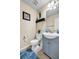 This bathroom includes a stylish vanity with a sink and a toilet, complemented by neutral decor at 6031 Autumn Green Dr, Fairburn, GA 30213