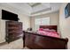 Bedroom featuring neutral walls, a large dresser, and a comfortable bed perfect for relaxing at 6031 Autumn Green Dr, Fairburn, GA 30213