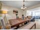 Bright dining room featuring a wooden table with a bench and chairs at 6031 Autumn Green Dr, Fairburn, GA 30213