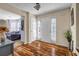 Inviting home foyer with new wooden floors, white door, and natural light at 6031 Autumn Green Dr, Fairburn, GA 30213