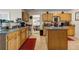 Spacious kitchen with wooden cabinets, a kitchen island, and stainless steel appliances at 6031 Autumn Green Dr, Fairburn, GA 30213
