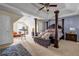 Large primary bedroom with a luxurious four-poster bed and plenty of space for a sitting area and desk at 6031 Autumn Green Dr, Fairburn, GA 30213