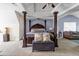 Spacious primary bedroom with a four-poster bed, high ceilings, and ample room for additional seating at 6031 Autumn Green Dr, Fairburn, GA 30213