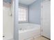 Bathroom showcasing a soaking tub, separate shower, and window for natural light at 315 Hillcrest Ln, Canton, GA 30115