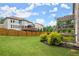 View of a large backyard with green grass, a wooden fence, and a raised deck with a pergola at 4316 Woodland Bank Blvd, Buford, GA 30518
