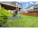 View of an outdoor backyard with a grassy yard and wooden fence at 4316 Woodland Bank Blvd, Buford, GA 30518