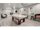 Finished basement with a pool table, wet bar, and luxury vinyl flooring at 4316 Woodland Bank Blvd, Buford, GA 30518