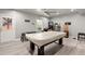 Finished basement features a pool table, luxury vinyl flooring and pinball machine at 4316 Woodland Bank Blvd, Buford, GA 30518
