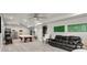Finished basement with a pool table, black leather couch, and multiple ceiling fans at 4316 Woodland Bank Blvd, Buford, GA 30518