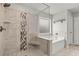 Bathroom featuring glass enclosed shower with decorative tile, soaking tub, and neutral tones at 4316 Woodland Bank Blvd, Buford, GA 30518