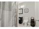 Bathroom featuring patterned shower curtain, toilet, vanity, and decoratively placed toilet paper at 4316 Woodland Bank Blvd, Buford, GA 30518