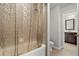 Bathroom with decorative shower curtain and tile flooring; vanity visible through the doorway at 4316 Woodland Bank Blvd, Buford, GA 30518
