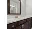 Bathroom featuring dark wood vanity, quartz countertops and stainless steel fixtures at 4316 Woodland Bank Blvd, Buford, GA 30518