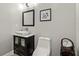 A well-lit bathroom showcases a modern vanity, toilet, decoratively displayed hand towels, and framed picture at 4316 Woodland Bank Blvd, Buford, GA 30518