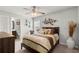 Bedroom featuring a ceiling fan, neutral color palette, and ensuite bath with a view of vanity at 4316 Woodland Bank Blvd, Buford, GA 30518
