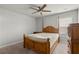 Bedroom featuring a wooden bed frame and soft neutral color scheme with bright natural light at 4316 Woodland Bank Blvd, Buford, GA 30518