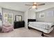 Bedroom with a ceiling fan, comfy chair, and large window for plenty of natural light at 4316 Woodland Bank Blvd, Buford, GA 30518