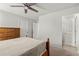 Bedroom with tan carpet, white walls, ceiling fan and a view into the ensuite bathroom at 4316 Woodland Bank Blvd, Buford, GA 30518