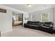 Comfortable bonus room with black leather reclining couch and a peek into the main bedroom at 4316 Woodland Bank Blvd, Buford, GA 30518