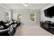 Spacious bonus room features large windows and a modern entertainment center with flat screen TV at 4316 Woodland Bank Blvd, Buford, GA 30518