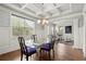 Formal dining room features coffered ceilings, hardwood floors, and large windows at 4316 Woodland Bank Blvd, Buford, GA 30518