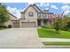 Charming two-story brick home featuring a manicured lawn, three-car garage, and inviting front porch at 4316 Woodland Bank Blvd, Buford, GA 30518