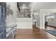 Inviting foyer featuring hardwood floors, a modern art piece, and staircase leading to the upper level at 4316 Woodland Bank Blvd, Buford, GA 30518