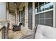Inviting front porch featuring comfortable seating, stone columns, and stylish brick facade at 4316 Woodland Bank Blvd, Buford, GA 30518