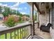 Inviting covered porch with stone pillars, comfortable seating, and a view of the front yard at 4316 Woodland Bank Blvd, Buford, GA 30518