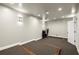 A home gym features tiered floors, recessed lighting, and enough space for cardio and weight training equipment at 4316 Woodland Bank Blvd, Buford, GA 30518