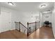 Hallway featuring hardwood floors, a staircase, and a view of the office and entryway at 4316 Woodland Bank Blvd, Buford, GA 30518