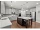 Elegant kitchen features stainless steel appliances, gray cabinets and a large center island at 4316 Woodland Bank Blvd, Buford, GA 30518
