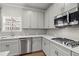 Modern kitchen featuring stainless steel appliances and custom cabinets at 4316 Woodland Bank Blvd, Buford, GA 30518
