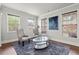 Bright living room boasts three large windows and comfortable seating at 4316 Woodland Bank Blvd, Buford, GA 30518