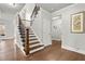 Elegant staircase with hardwood steps, black iron railings, and a view of the upper level at 4316 Woodland Bank Blvd, Buford, GA 30518
