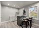 A convenient wet bar sits beside a window and in front of two barstools, great for mixing drinks at 4316 Woodland Bank Blvd, Buford, GA 30518