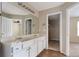 Bathroom features a double vanity, large mirror, and view to walk-in closet at 700 Celeste Sw Ln, Atlanta, GA 30331