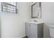 Updated bathroom with a gray vanity, new hardware, modern mirror, and new light fixture at 700 Celeste Sw Ln, Atlanta, GA 30331