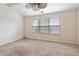 Bright bedroom with a ceiling fan, neutral walls, and natural light from the large window at 700 Celeste Sw Ln, Atlanta, GA 30331