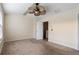 Bedroom features plush carpeting, neutral paint, a ceiling fan, and a doorway to the upstairs at 700 Celeste Sw Ln, Atlanta, GA 30331