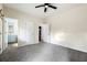 Spacious carpeted bedroom with ceiling fan, closet, and doors to an ensuite bathroom and another room at 700 Celeste Sw Ln, Atlanta, GA 30331