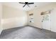 Large, bright carpeted bedroom with a ceiling fan and a door to the backyard at 700 Celeste Sw Ln, Atlanta, GA 30331
