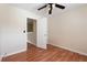 A neutral bedroom with laminate wood flooring and ceiling fan at 700 Celeste Sw Ln, Atlanta, GA 30331