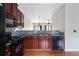 Efficient kitchen featuring black appliances and granite countertops at 700 Celeste Sw Ln, Atlanta, GA 30331