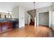 View of kitchen with granite counters, appliances, hardwood floors, and open staircase at 700 Celeste Sw Ln, Atlanta, GA 30331